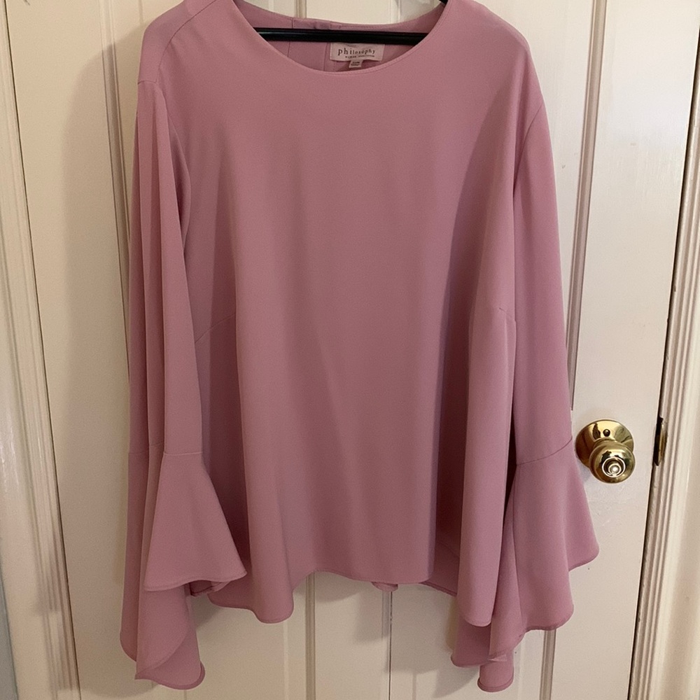 Beautiful blush bell sleeve blouse. So flattering and goes with everything